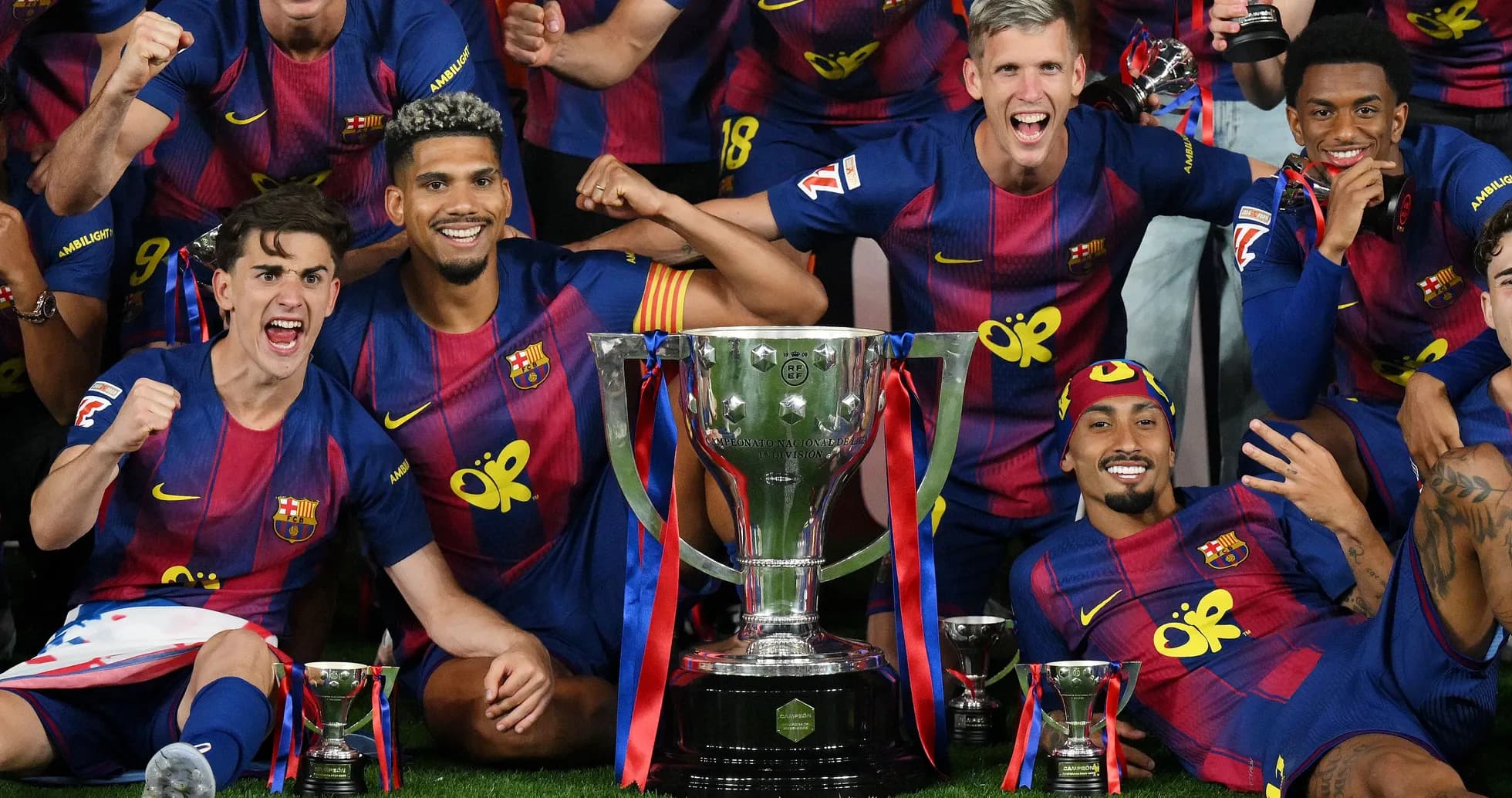 Barcelona players celebrating with trophies after victory Barcelona players celebrating with trophies after victory