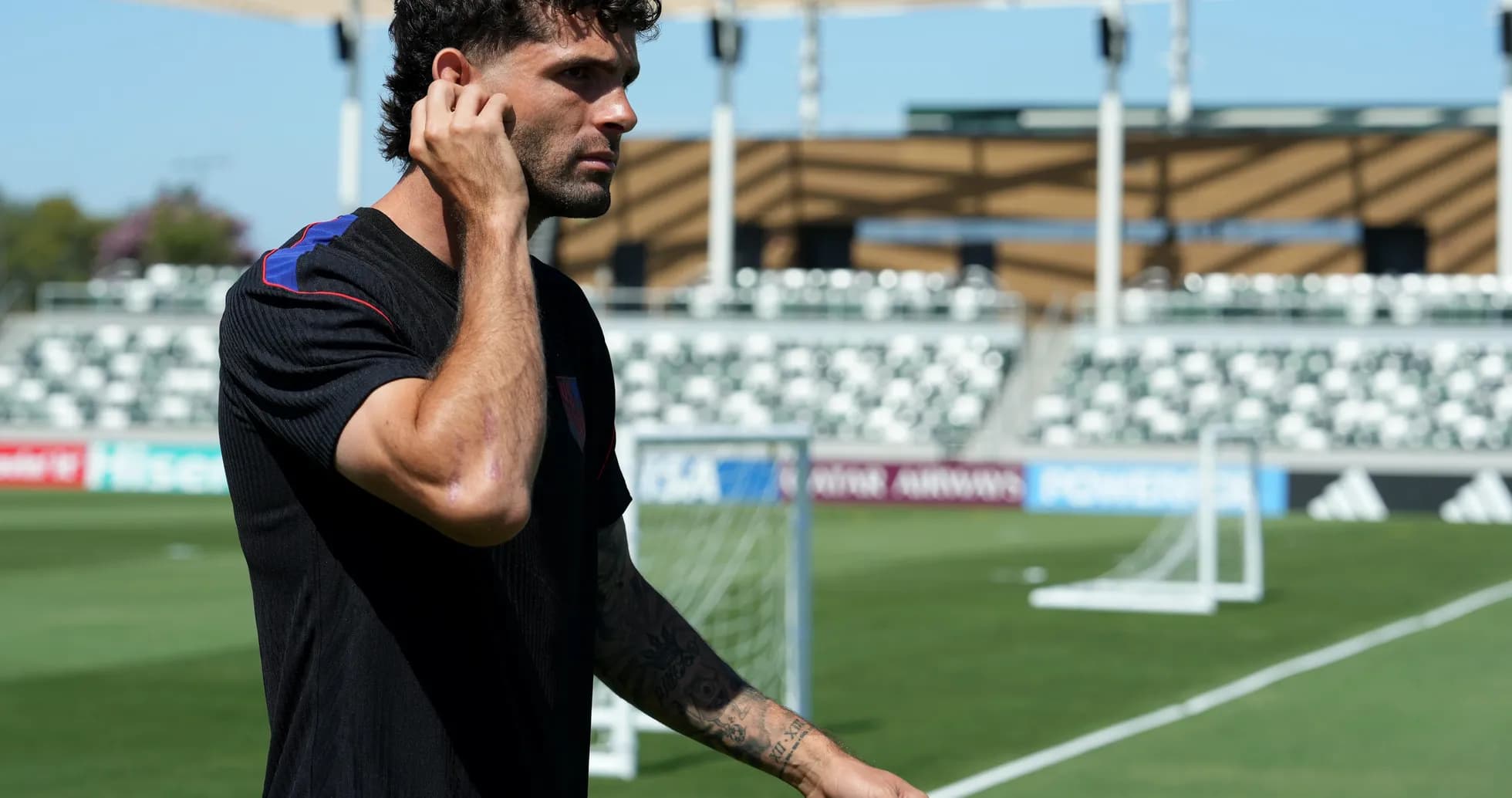 Player walking on football pitch before match Player walking on football pitch before match