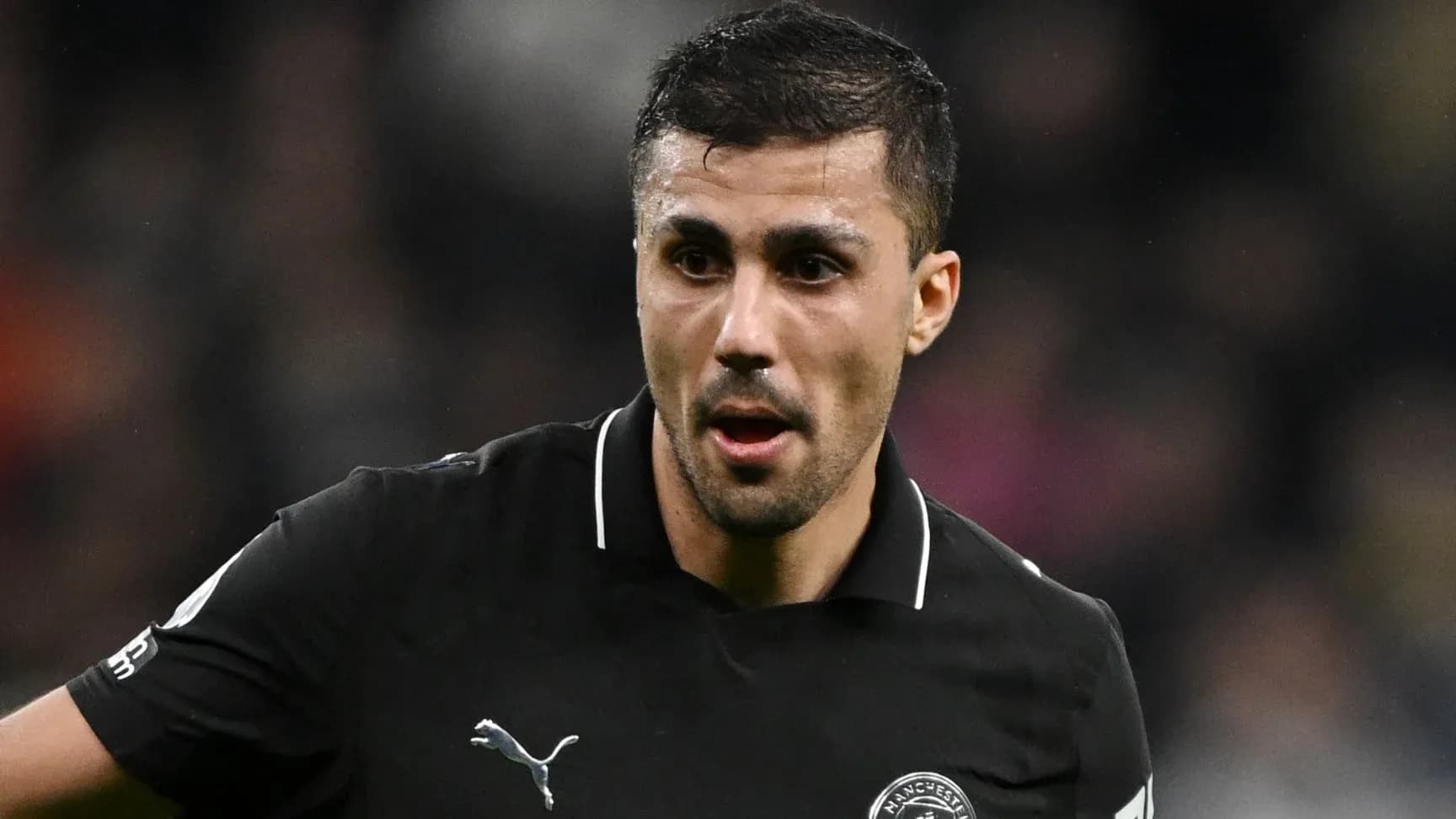 Player in black kit during a match Player in black kit during a match
