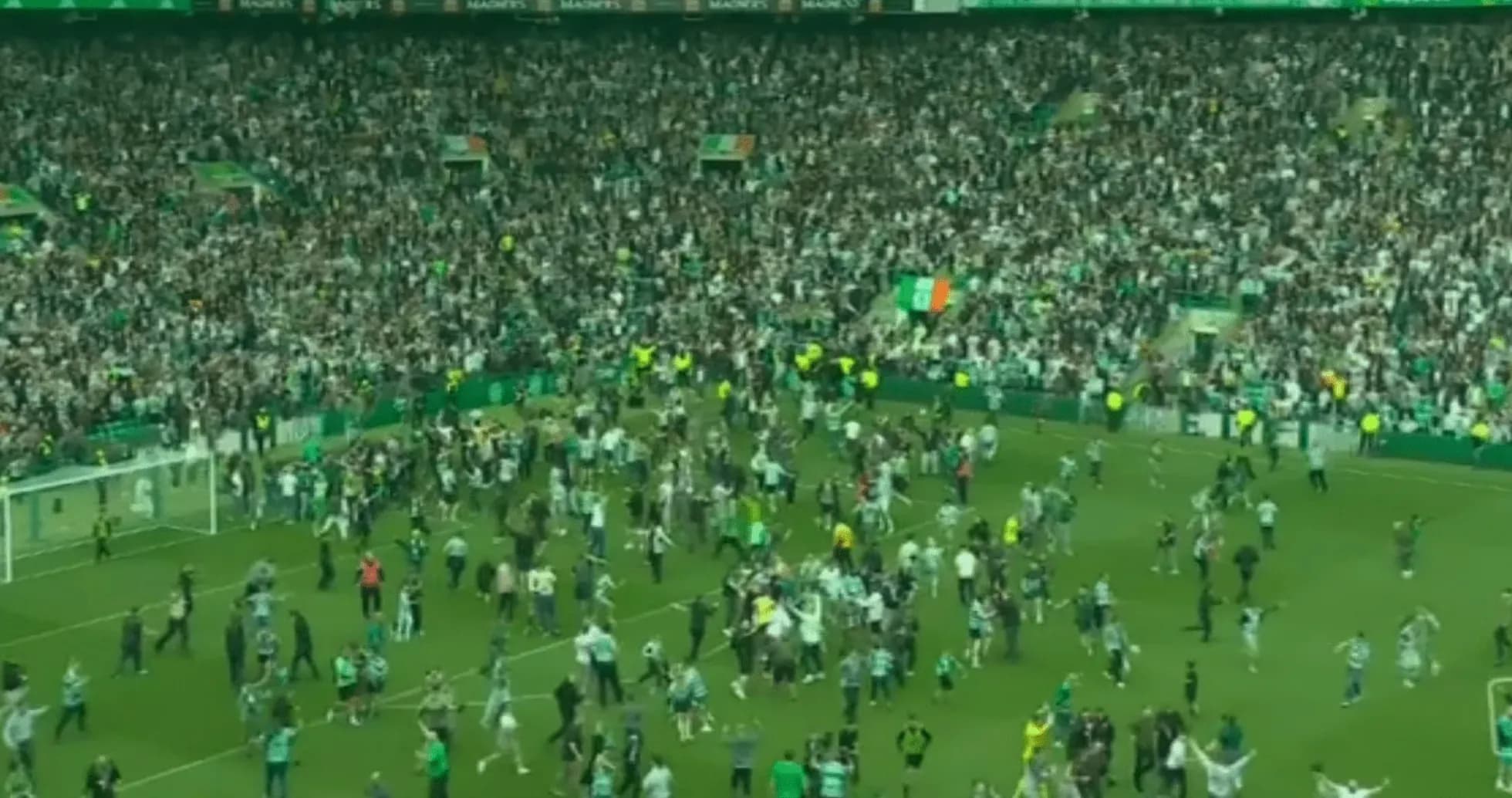 Fans celebrating on the pitch after a match Fans celebrating on the pitch after a match