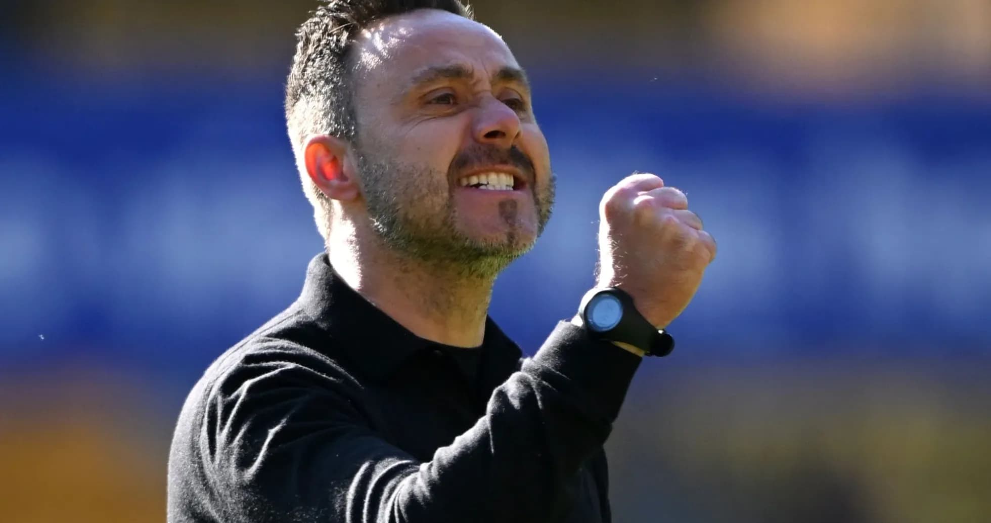 Coach celebrating with clenched fist on sidelines Coach celebrating with clenched fist on sidelines