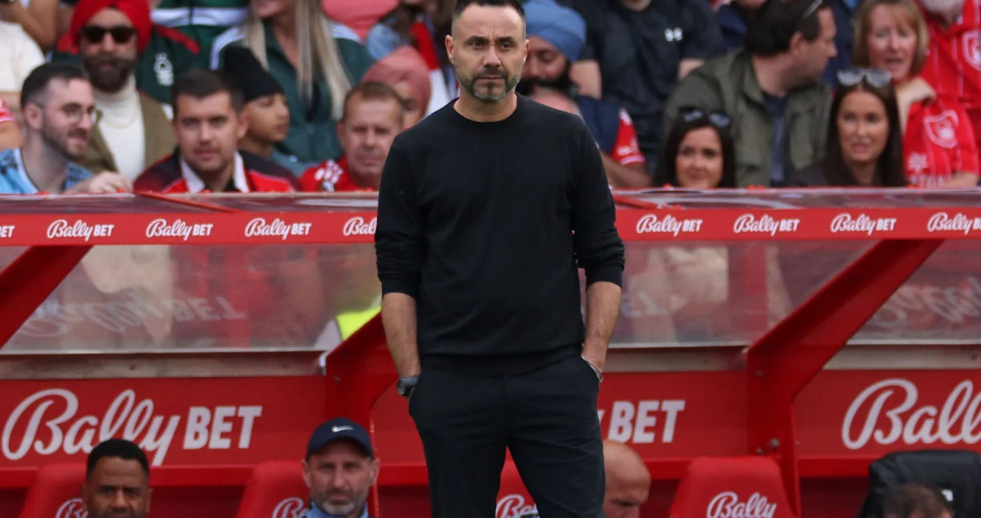 Coach standing on the sidelines during a match Coach standing on the sidelines during a match
