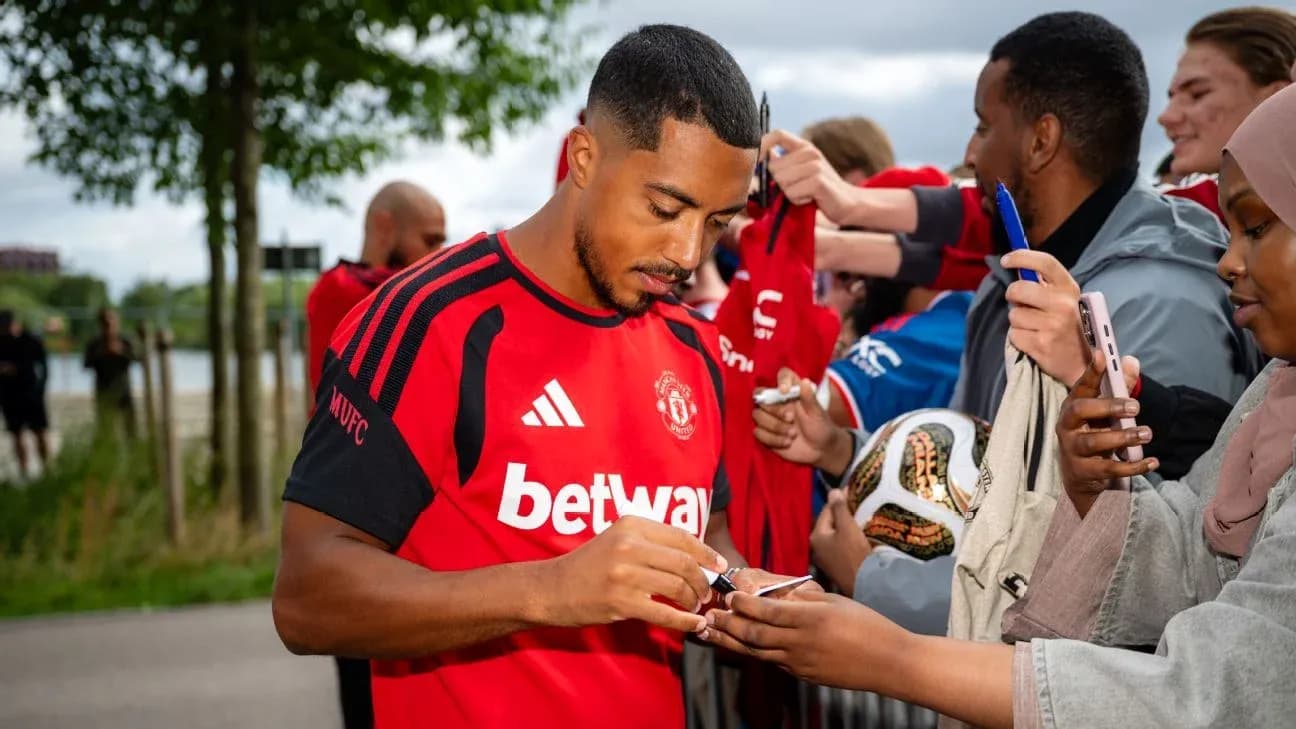 Player signing autographs for fans outside venue Player signing autographs for fans outside venue