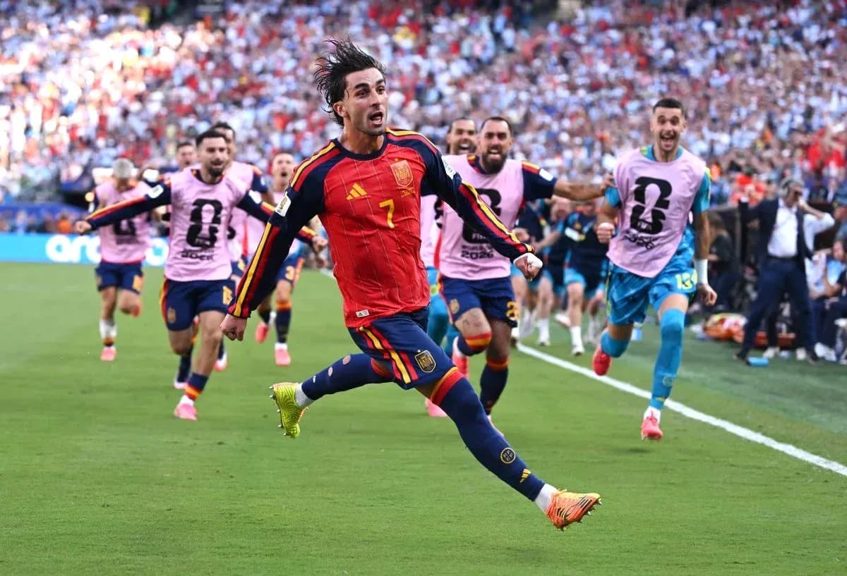 Player celebrating a goal with teammates during match Player celebrating a goal with teammates during match