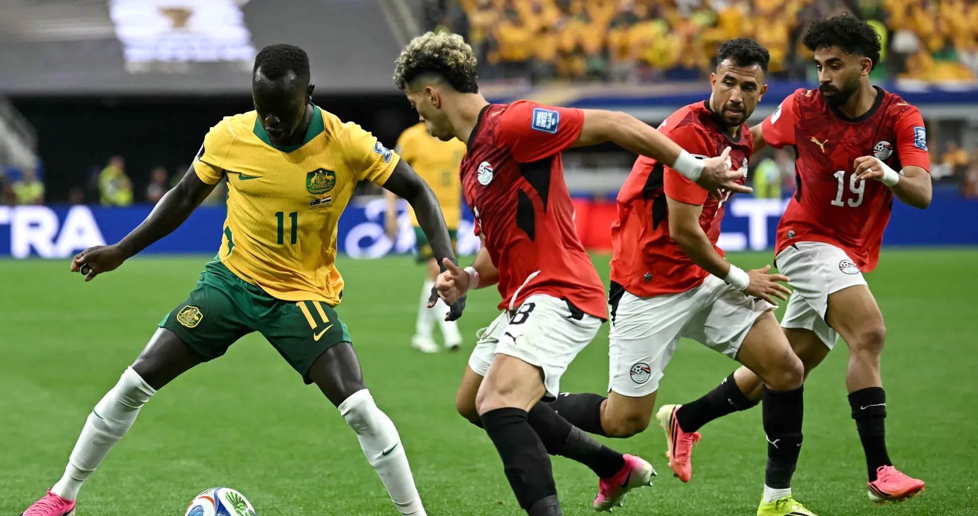 Player in yellow dribbling past defenders in red Player in yellow dribbling past defenders in red