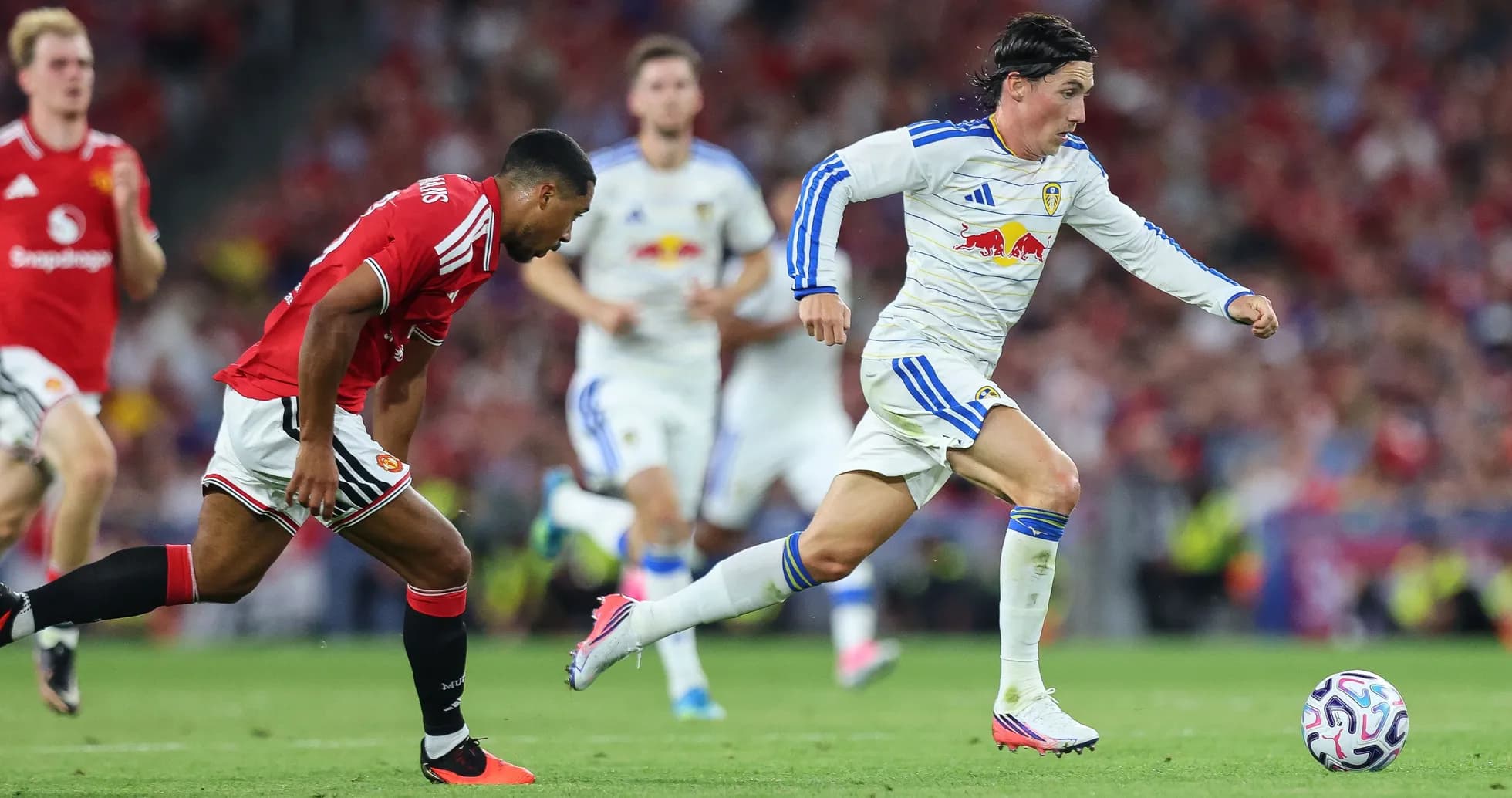 Leeds player sprinting with ball against Manchester United Leeds player sprinting with ball against Manchester United