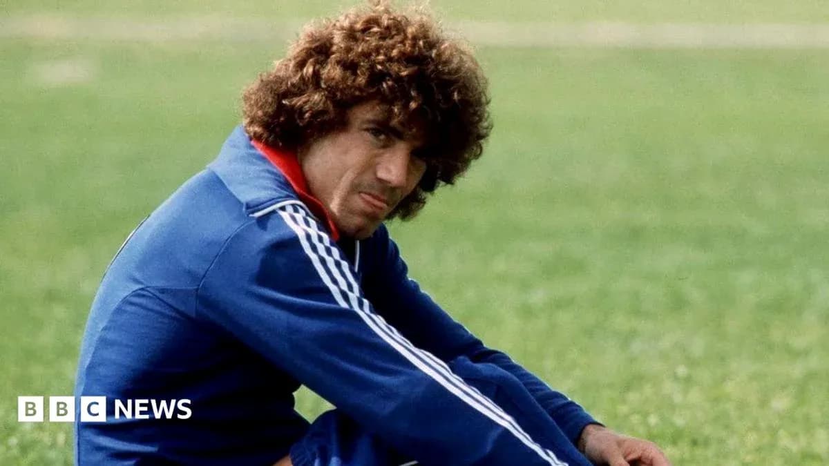 Football player sitting on grass field in training gear Football player sitting on grass field in training gear