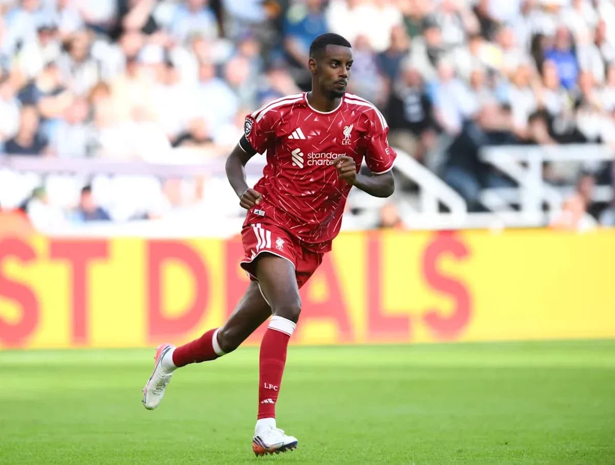 Player running on the field in red kit Player running on the field in red kit