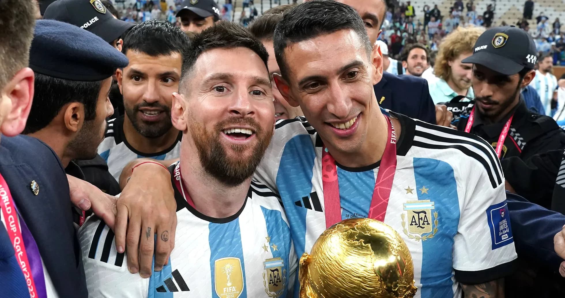 Messi and Di María celebrating with FIFA World Cup trophy Messi and Di María celebrating with FIFA World Cup trophy