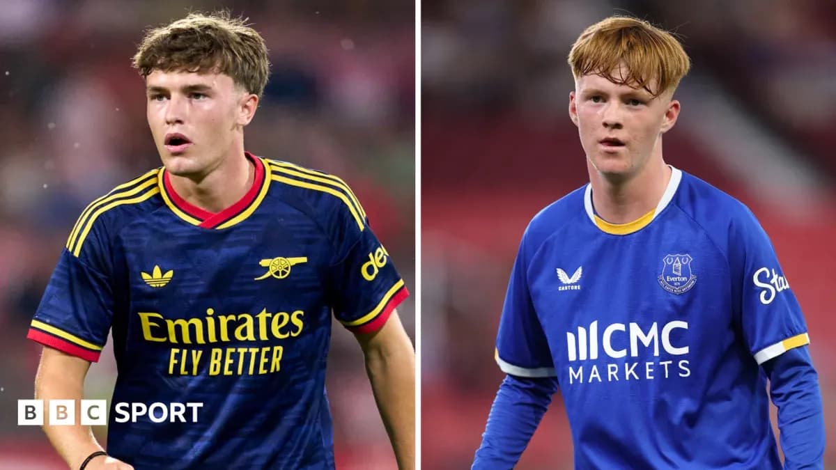Two young football players in team kits Two young football players in team kits