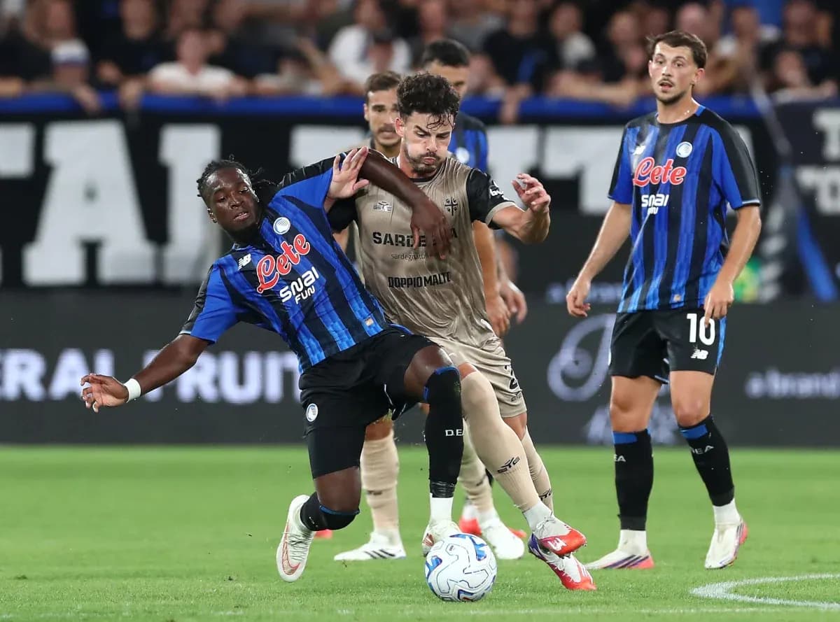 Atalanta player tackling Cagliari opponent during match Atalanta player tackling Cagliari opponent during match