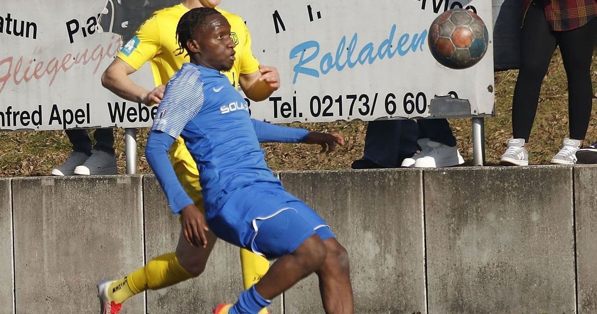 Two players competing for the ball in football match Two players competing for the ball in football match