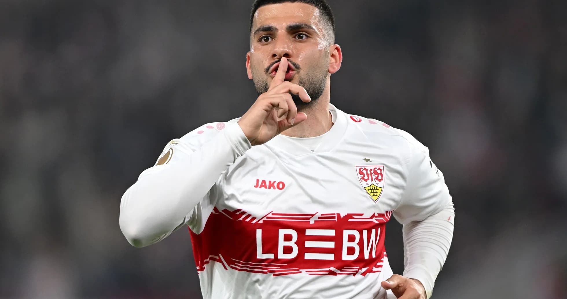 Player celebrating goal with a shushing gesture Player celebrating goal with a shushing gesture