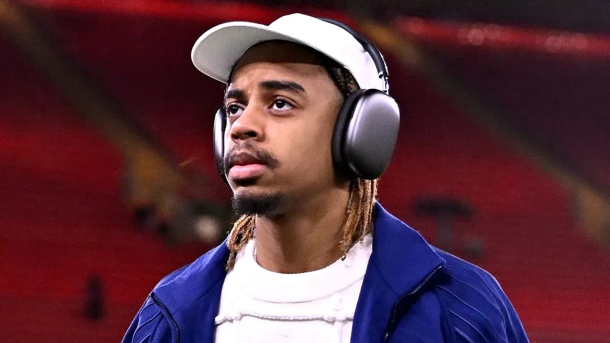 Player walking with headphones at stadium entrance Player walking with headphones at stadium entrance