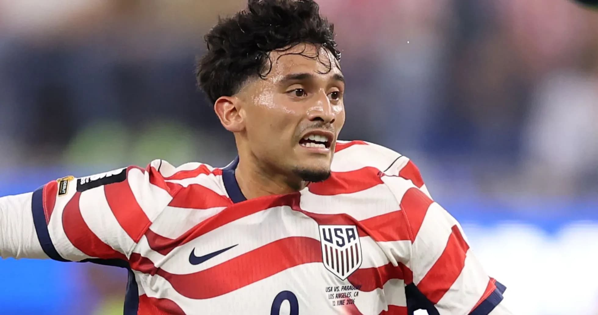 Player in striped USA jersey during match action Player in striped USA jersey during match action