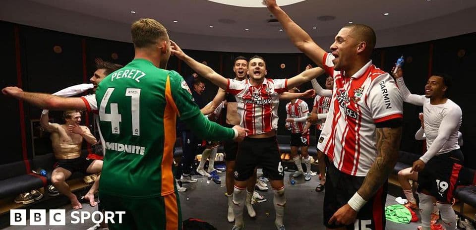 Team celebrating in locker room after match victory Team celebrating in locker room after match victory