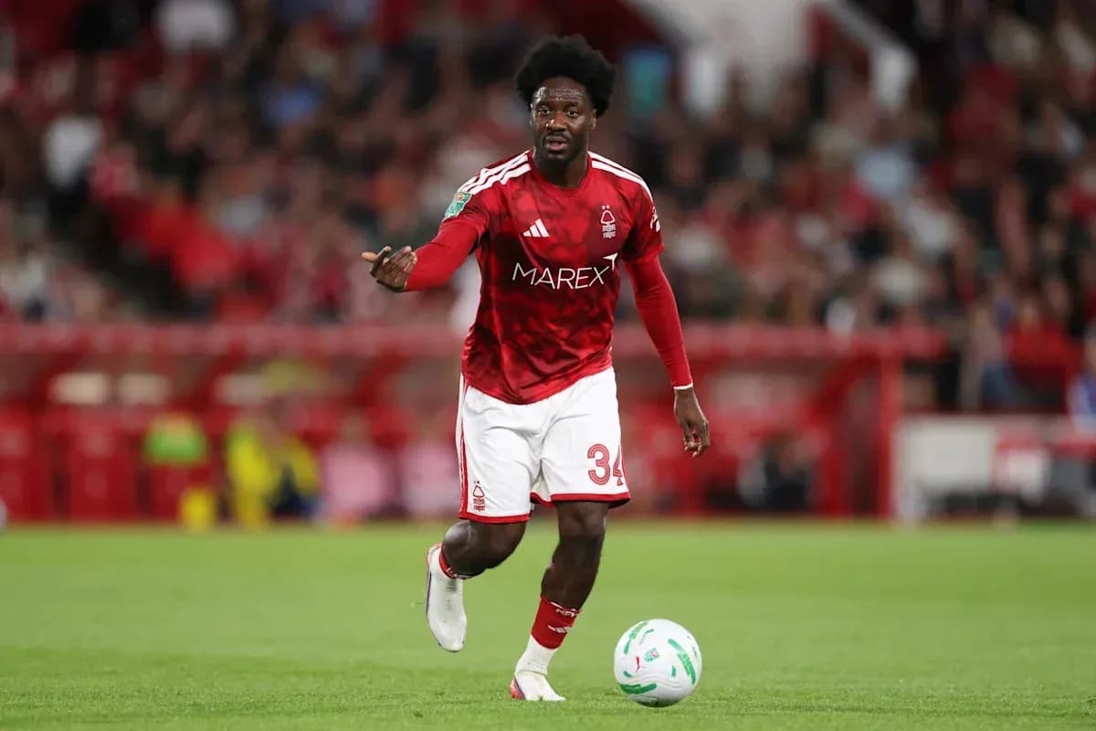 Player in red kit controlling ball during match Player in red kit controlling ball during match