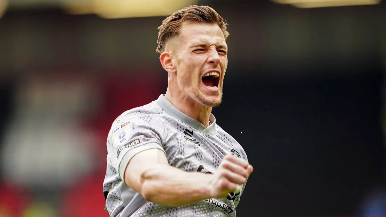 Player celebrating passionately on the pitch Player celebrating passionately on the pitch