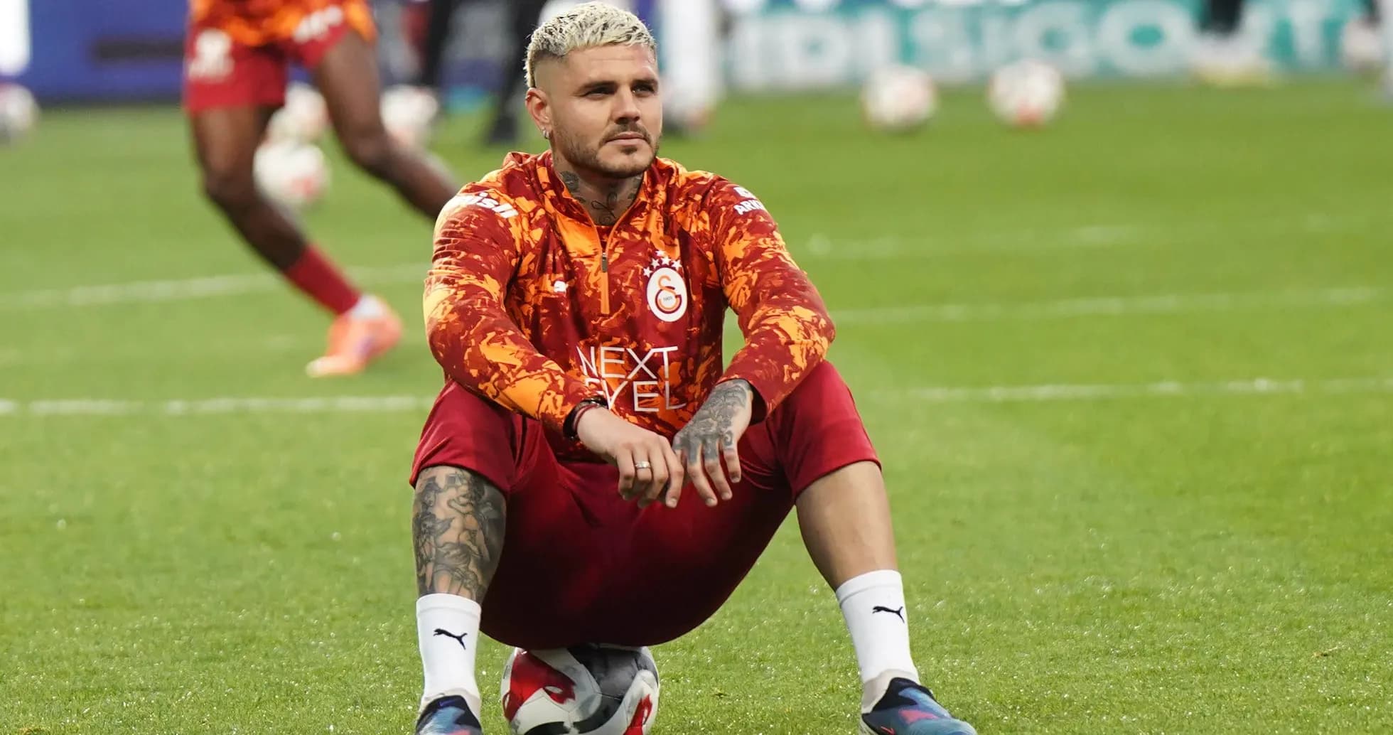 Player sitting on ball during warm-up session Player sitting on ball during warm-up session