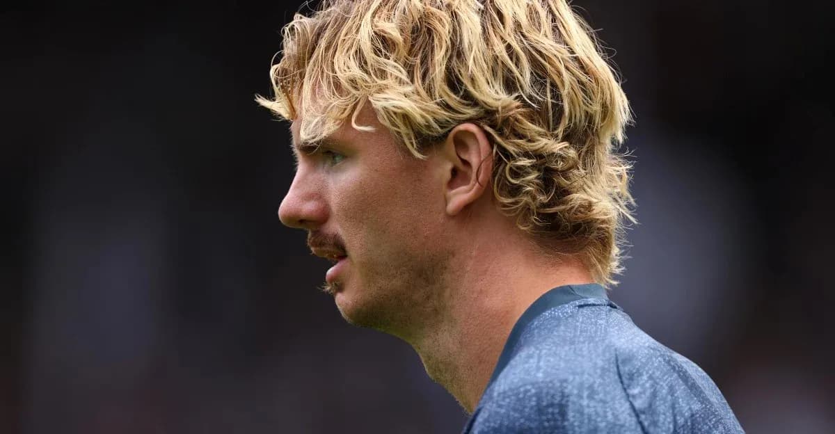 Player in profile with curly blonde hair and mustache Player in profile with curly blonde hair and mustache