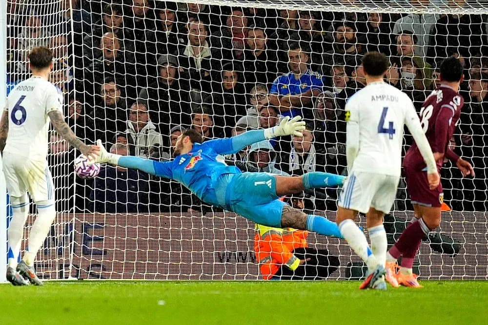 Goalkeeper diving to save a shot during match Goalkeeper diving to save a shot during match