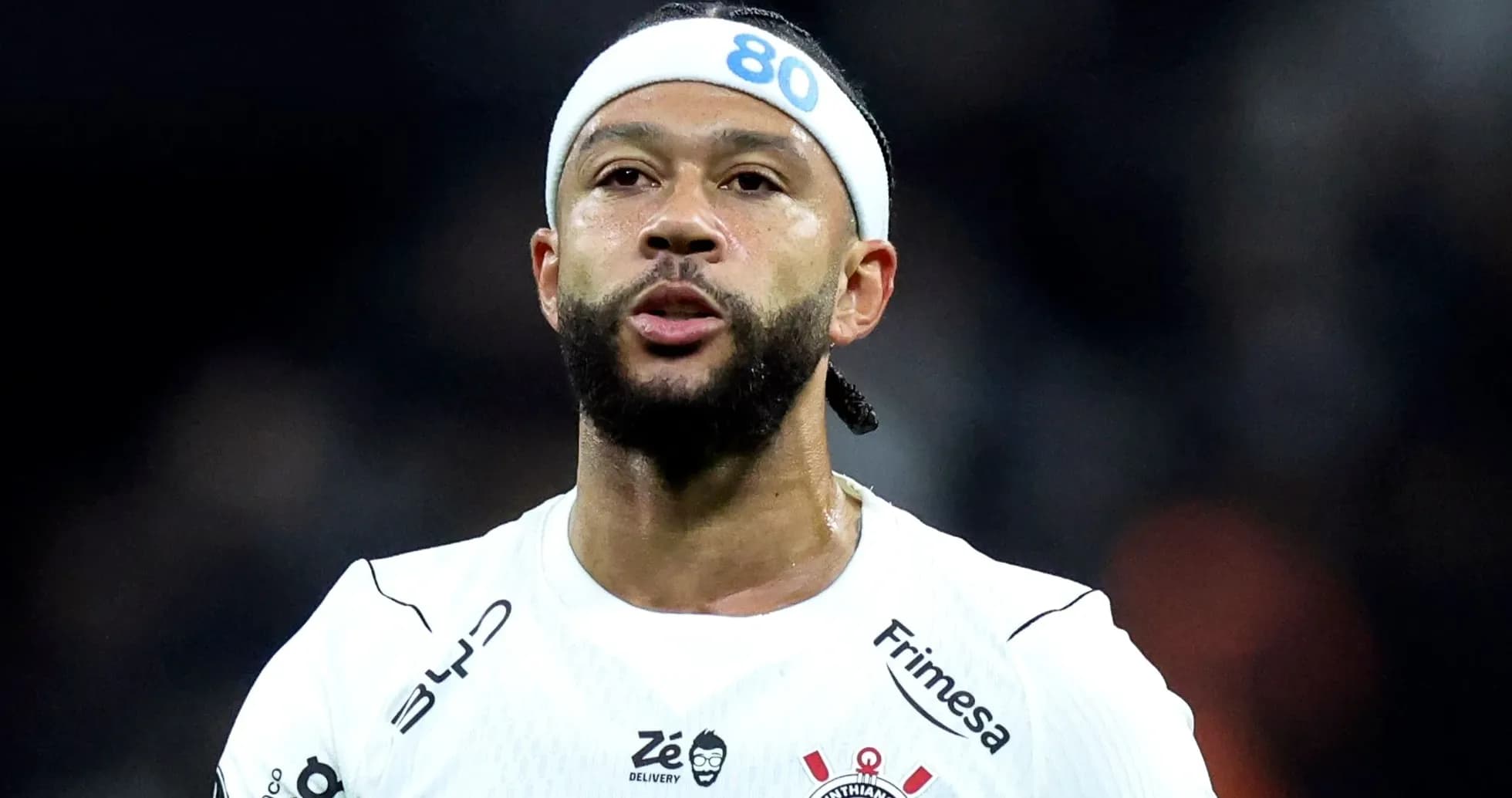 Player wearing white jersey with headband on field Player wearing white jersey with headband on field