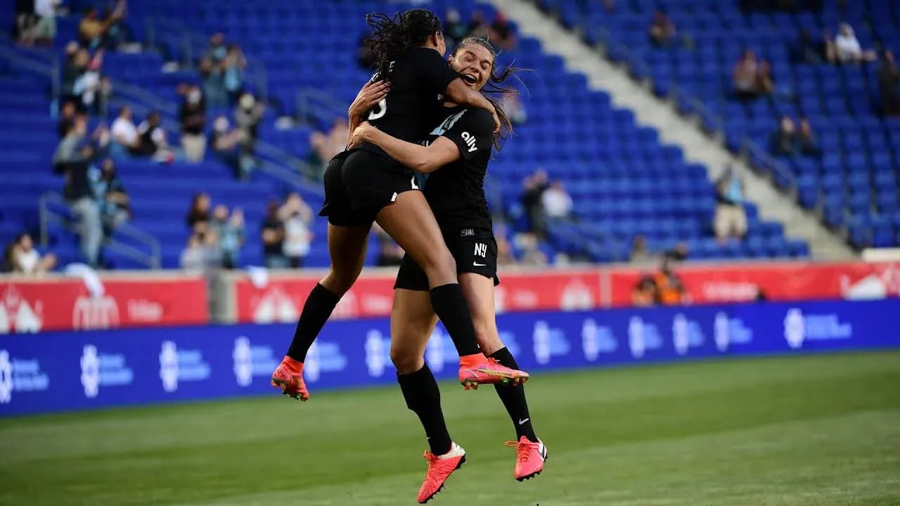 Players celebrating a goal during NWSL match Players celebrating a goal during NWSL match