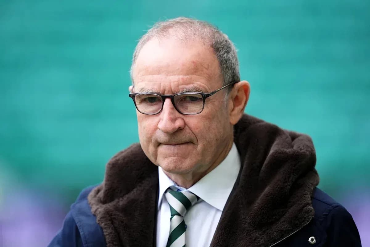 Man in glasses wearing a coat at stadium Man in glasses wearing a coat at stadium