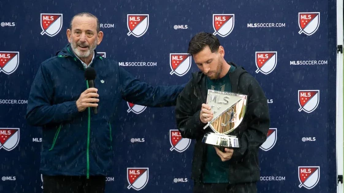 Official presenting award to player during rainy event Official presenting award to player during rainy event