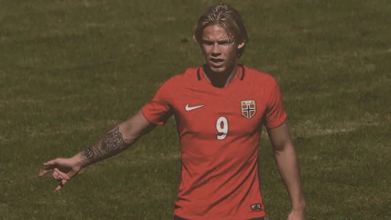 Player in red Norway jersey gesturing on field Player in red Norway jersey gesturing on field