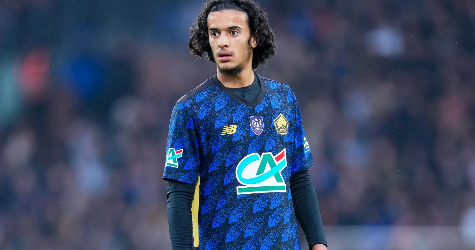 Player in blue jersey during a football match Player in blue jersey during a football match