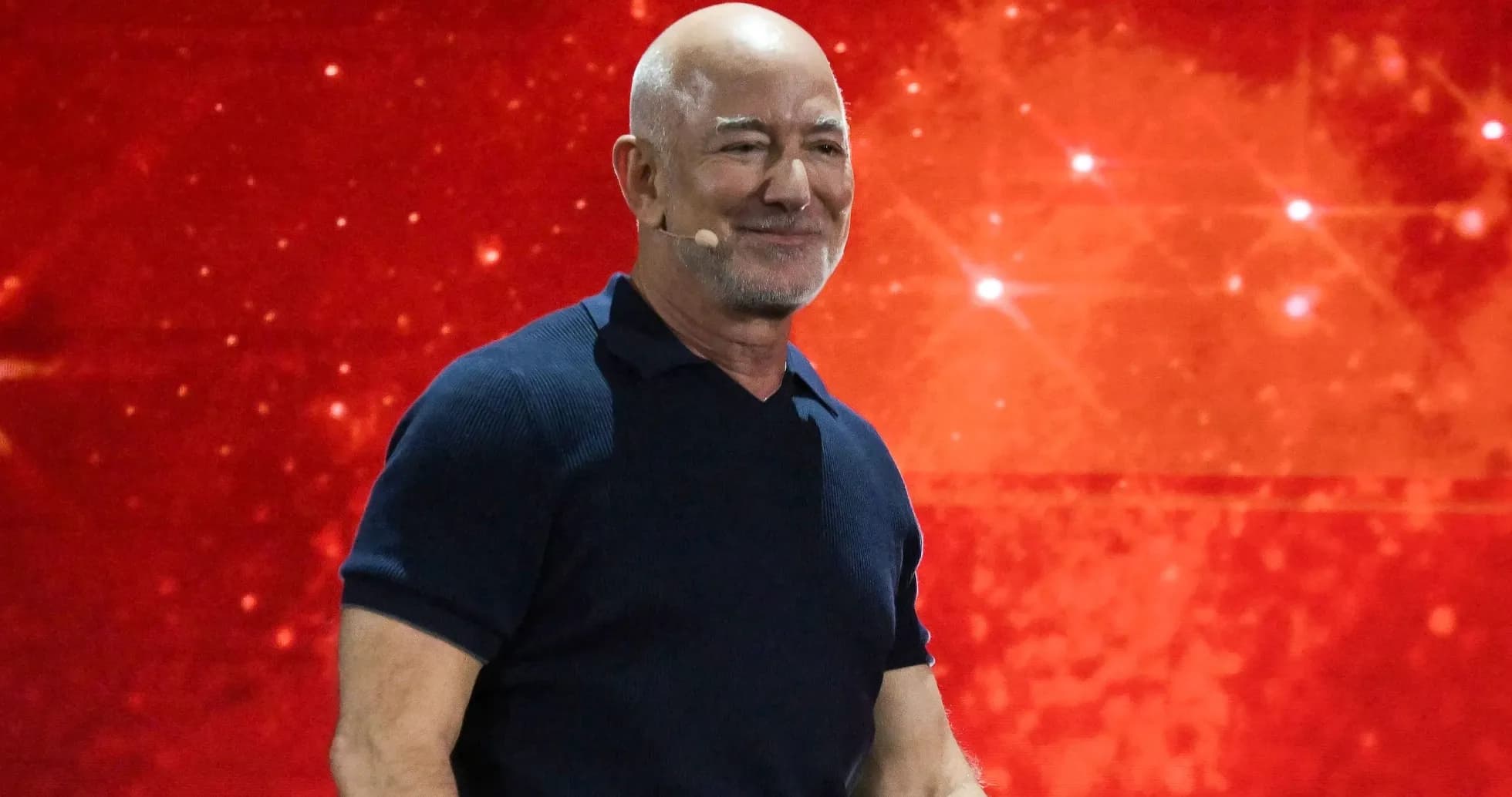 Speaker presenting against a red background Speaker presenting against a red background