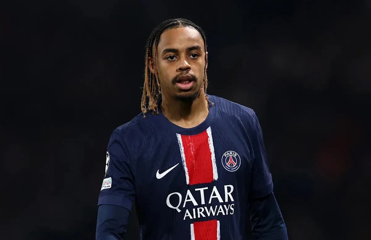 Football player wearing PSG jersey on the field Football player wearing PSG jersey on the field