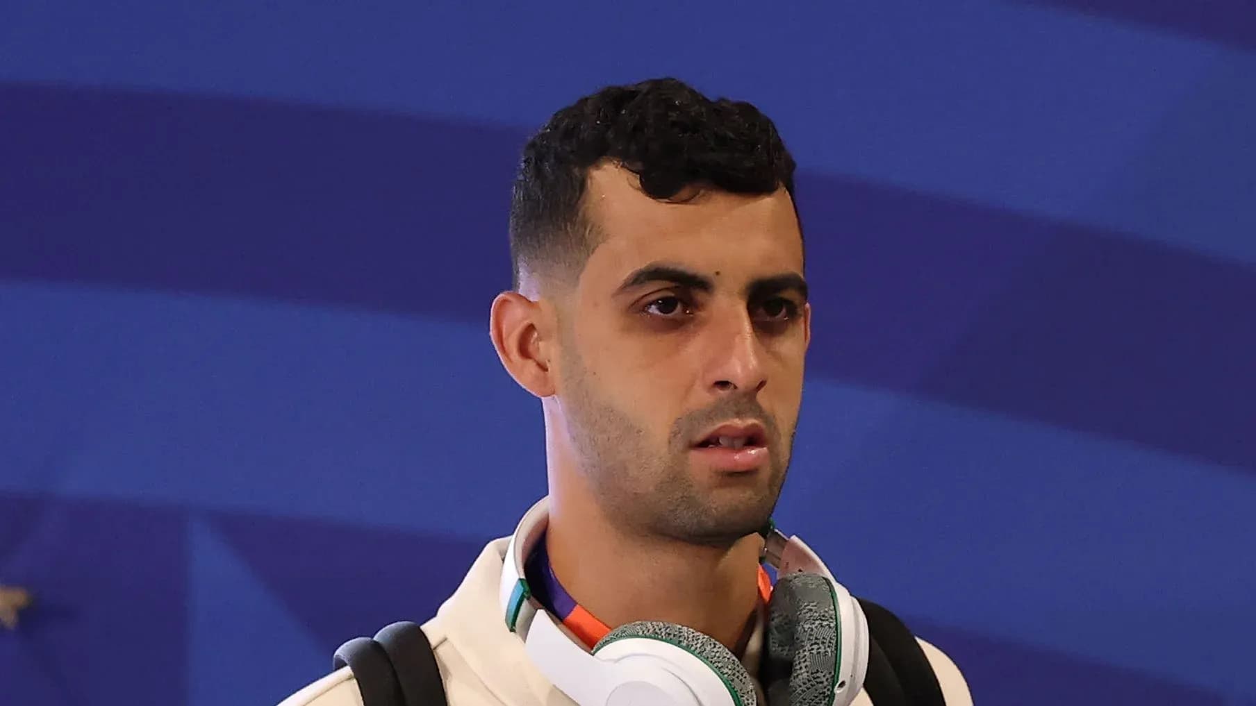 Player wearing headphones at an event Player wearing headphones at an event