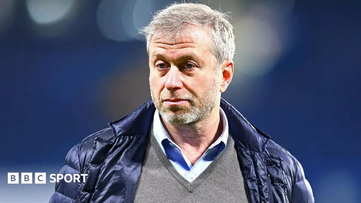 Man in a jacket at a sports venue Man in a jacket at a sports venue