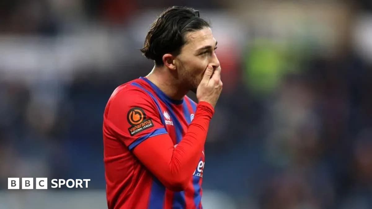 Player in red and blue kit during match Player in red and blue kit during match