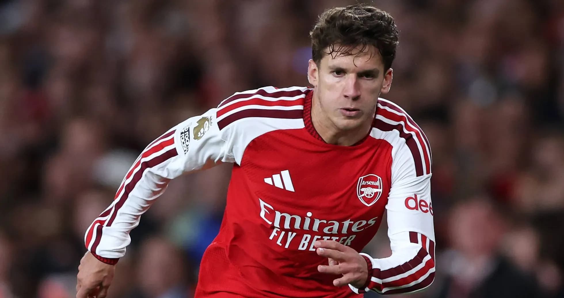 Arsenal player sprinting during a match Arsenal player sprinting during a match