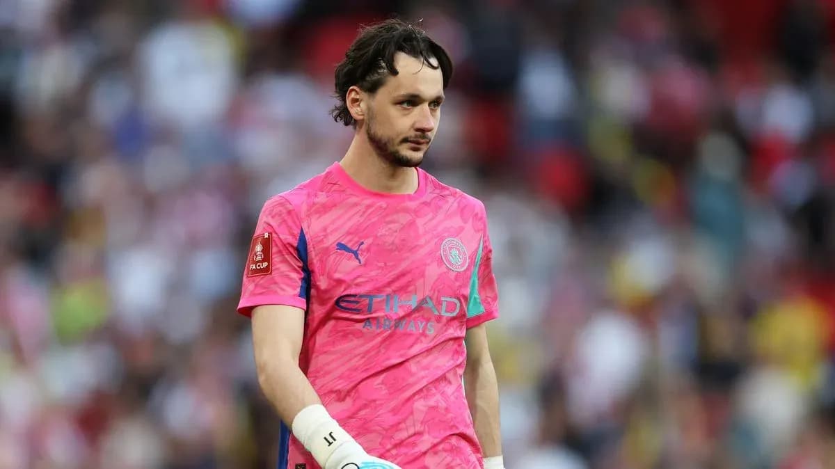 Goalkeeper in pink kit walking on the pitch Goalkeeper in pink kit walking on the pitch
