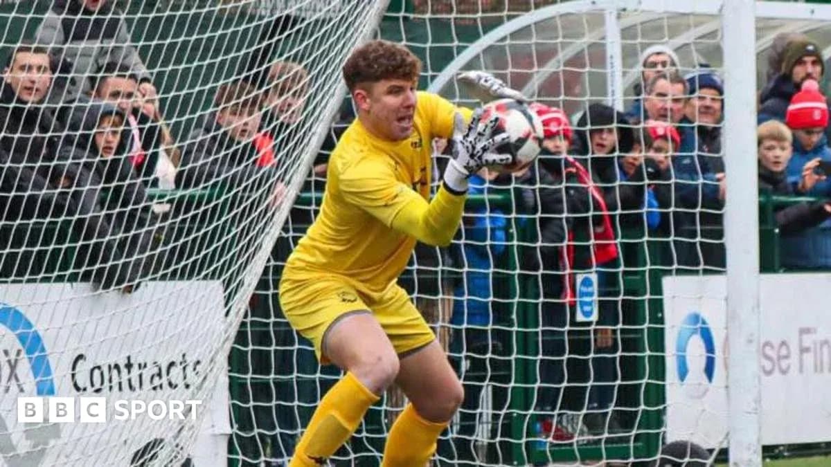 Goalkeeper making a save in front of fans Goalkeeper making a save in front of fans
