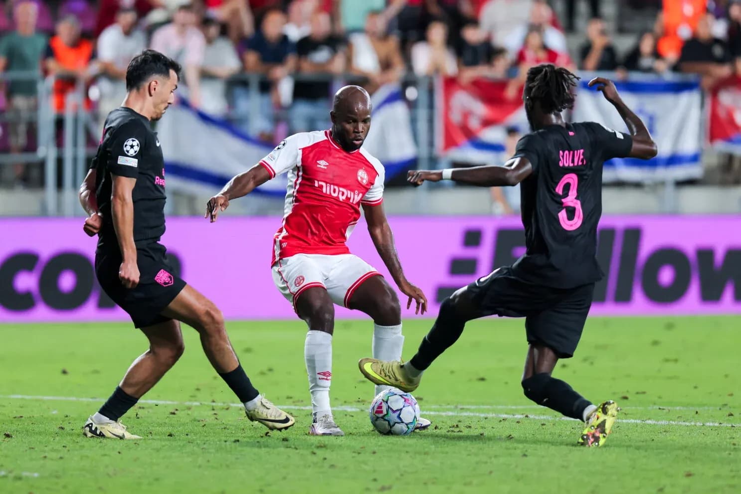 Two players contesting the ball in UEFA match Two players contesting the ball in UEFA match