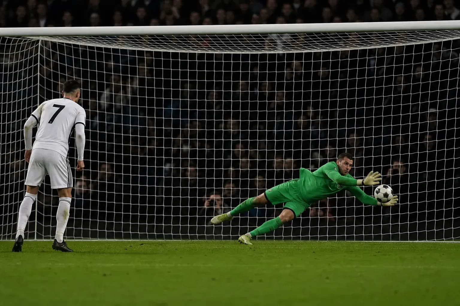 Goalkeeper saving a penalty kick during match Goalkeeper saving a penalty kick during match