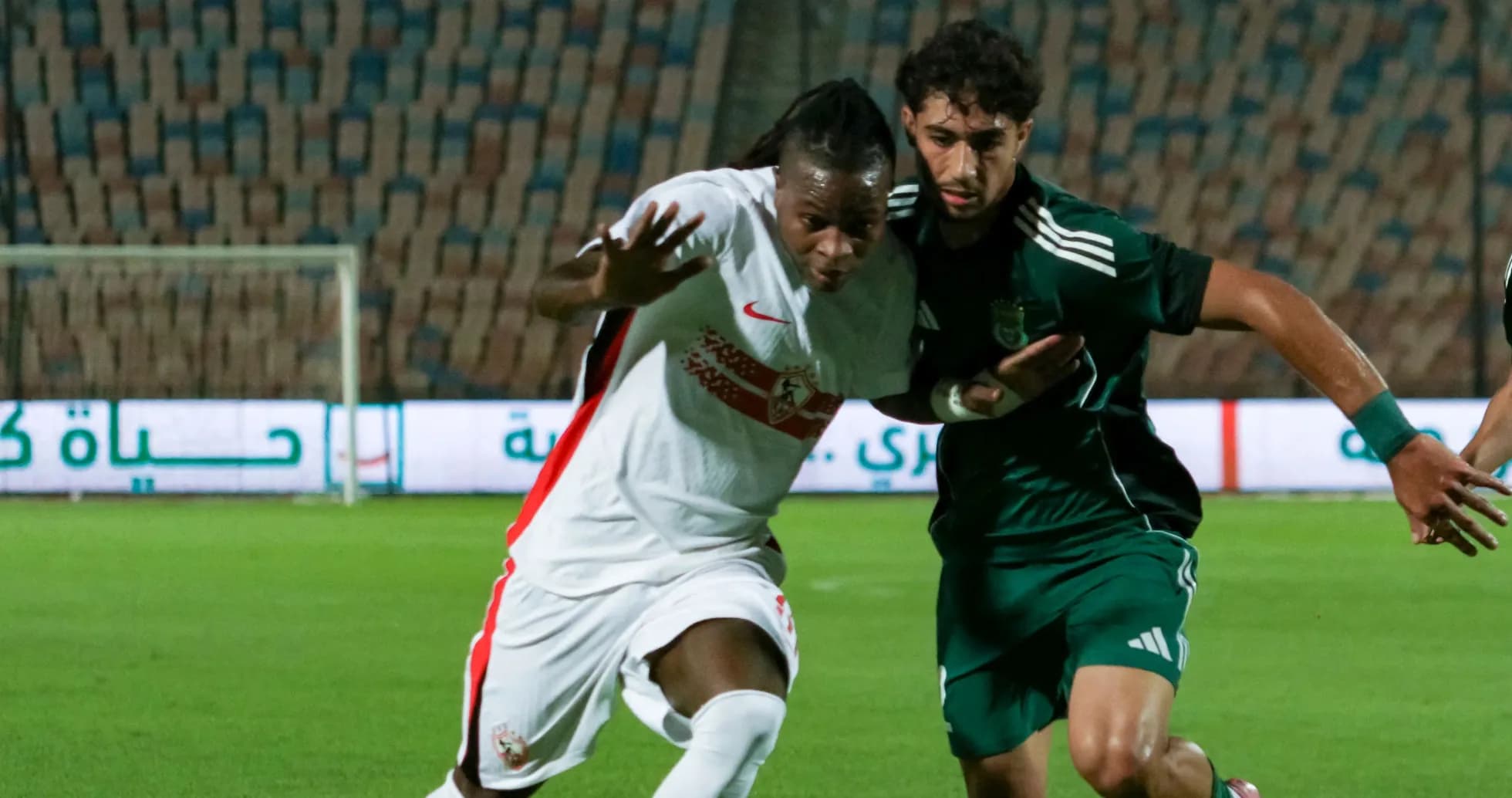 Two players contesting the ball during a match Two players contesting the ball during a match