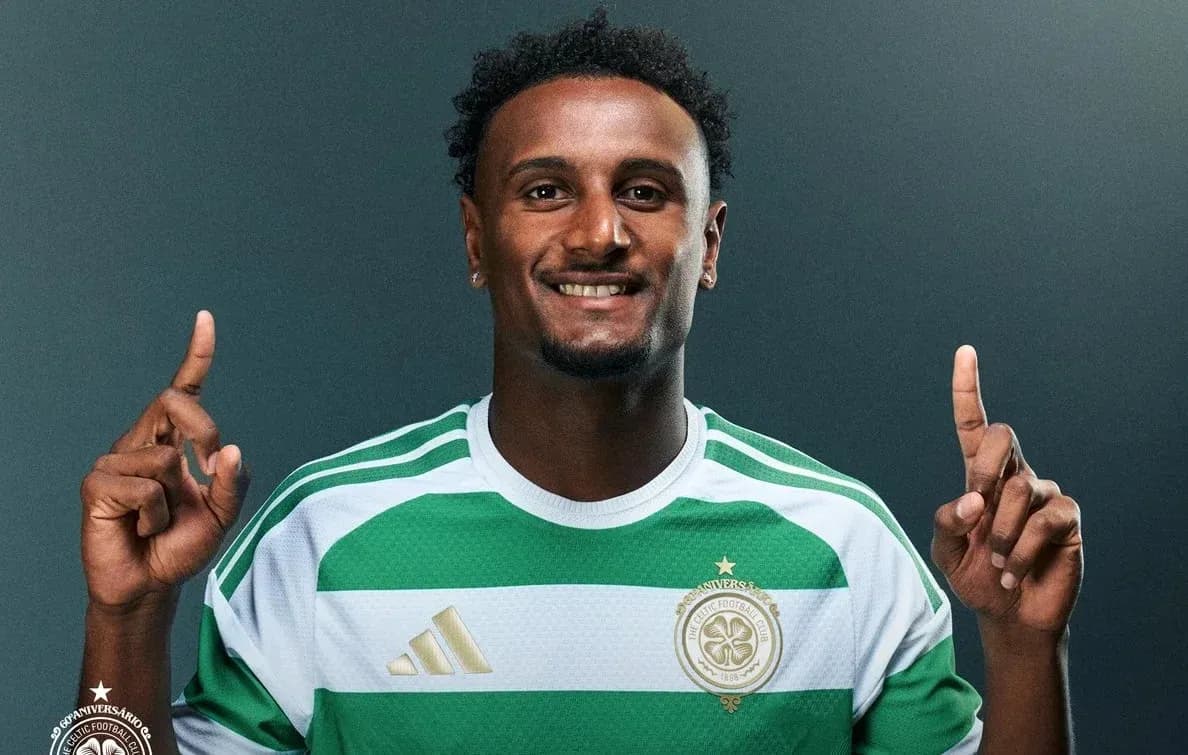 Player posing in Celtic FC jersey with fingers raised Player posing in Celtic FC jersey with fingers raised