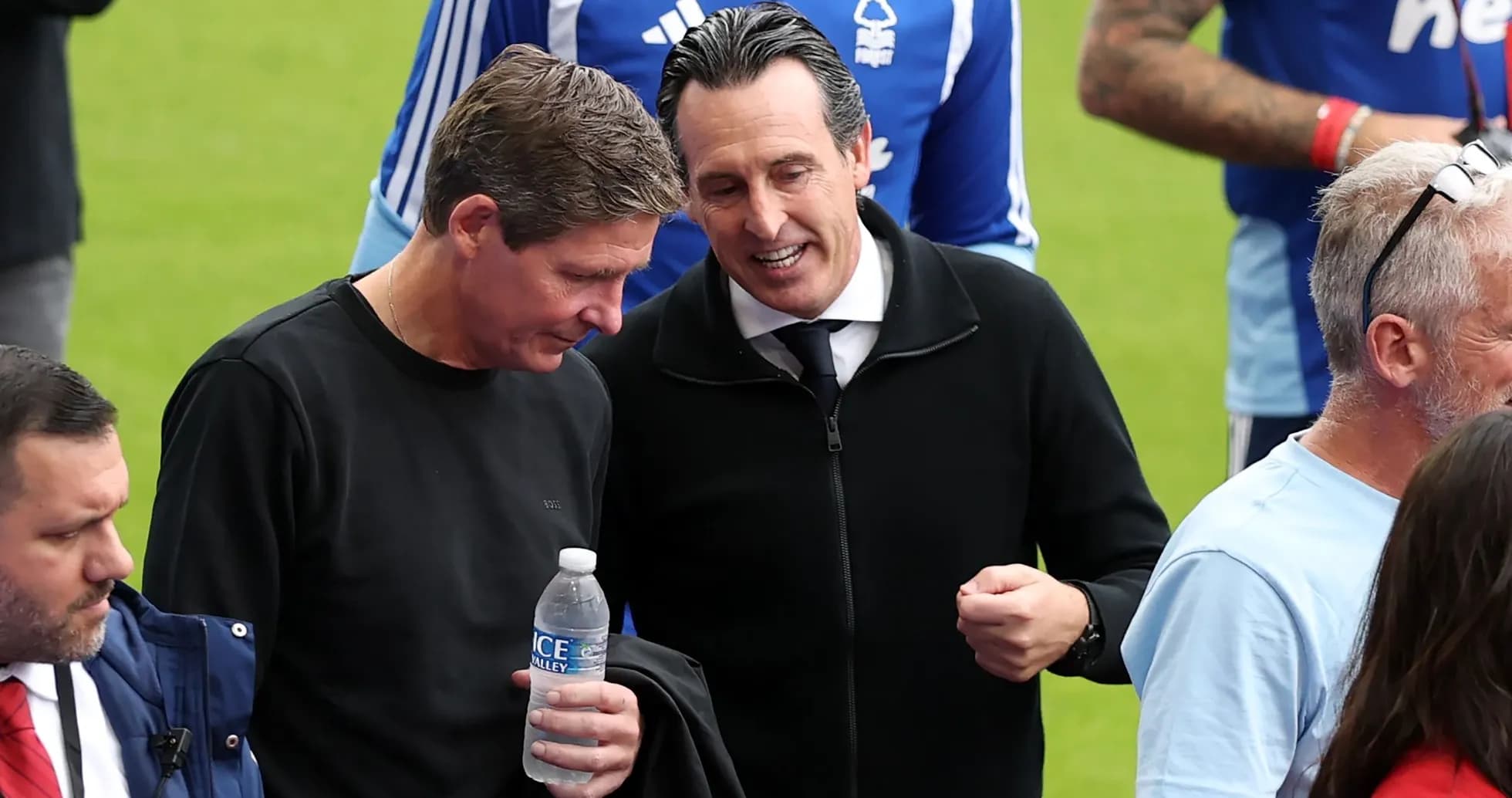 Two men talking on the pitch before a match Two men talking on the pitch before a match