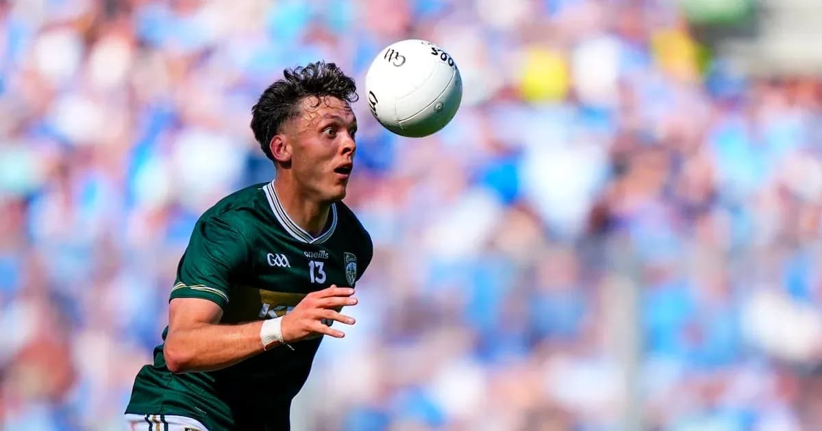 Player catching a ball during a GAA match Player catching a ball during a GAA match