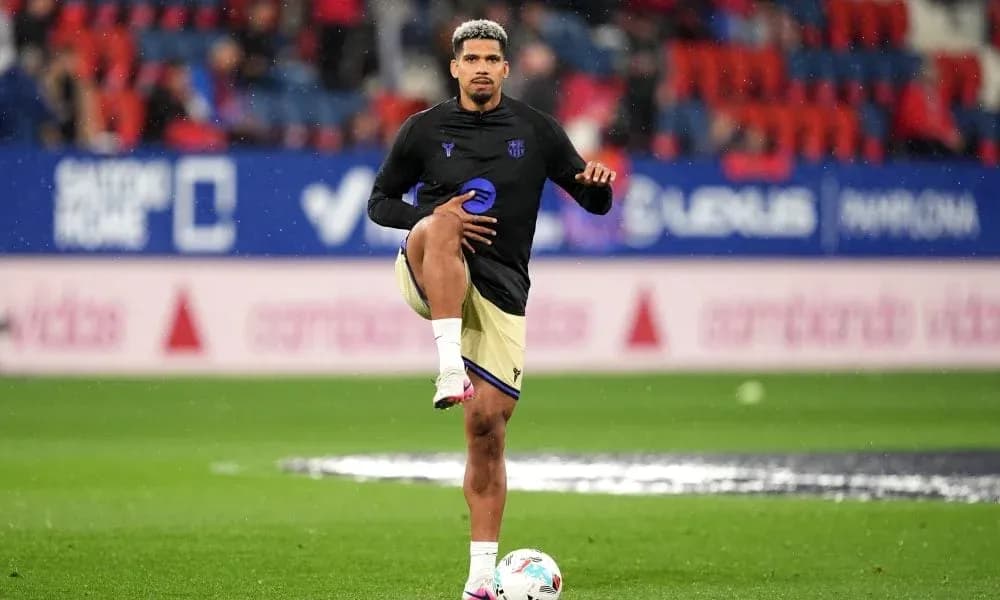 Player stretching during warm-up on pitch Player stretching during warm-up on pitch