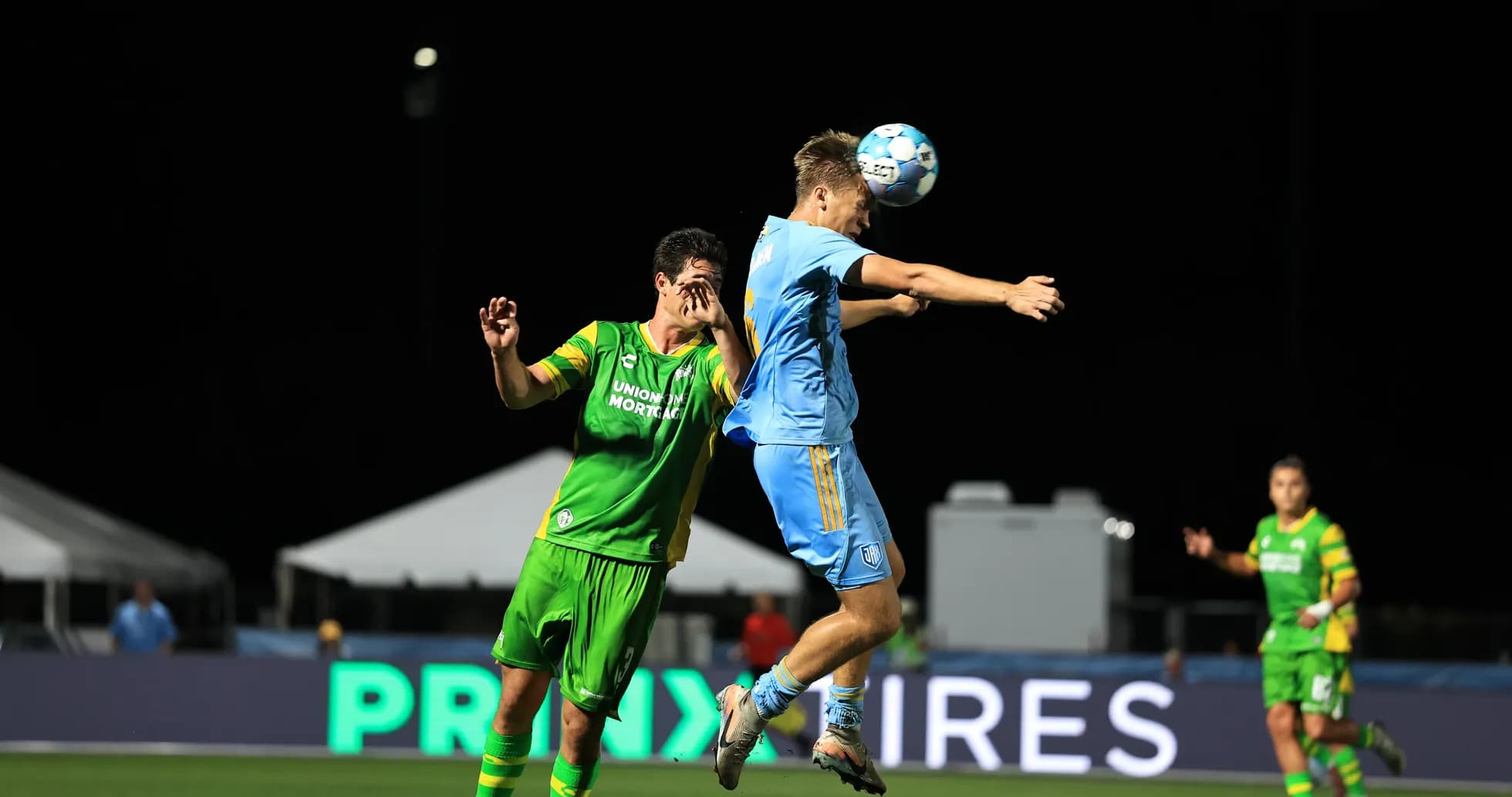 Players competing for the ball in USL match Players competing for the ball in USL match