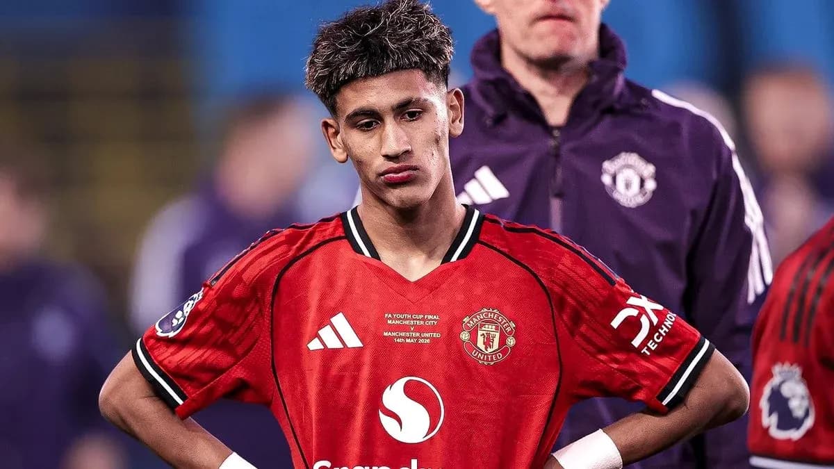 Young player in Manchester United kit looking down Young player in Manchester United kit looking down