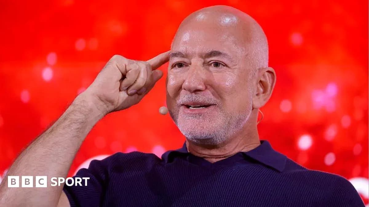 Person gesturing while speaking at event Person gesturing while speaking at event