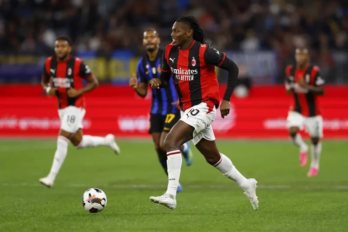 Player in AC Milan jersey running with the ball Player in AC Milan jersey running with the ball